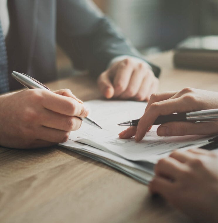 People signing documents
