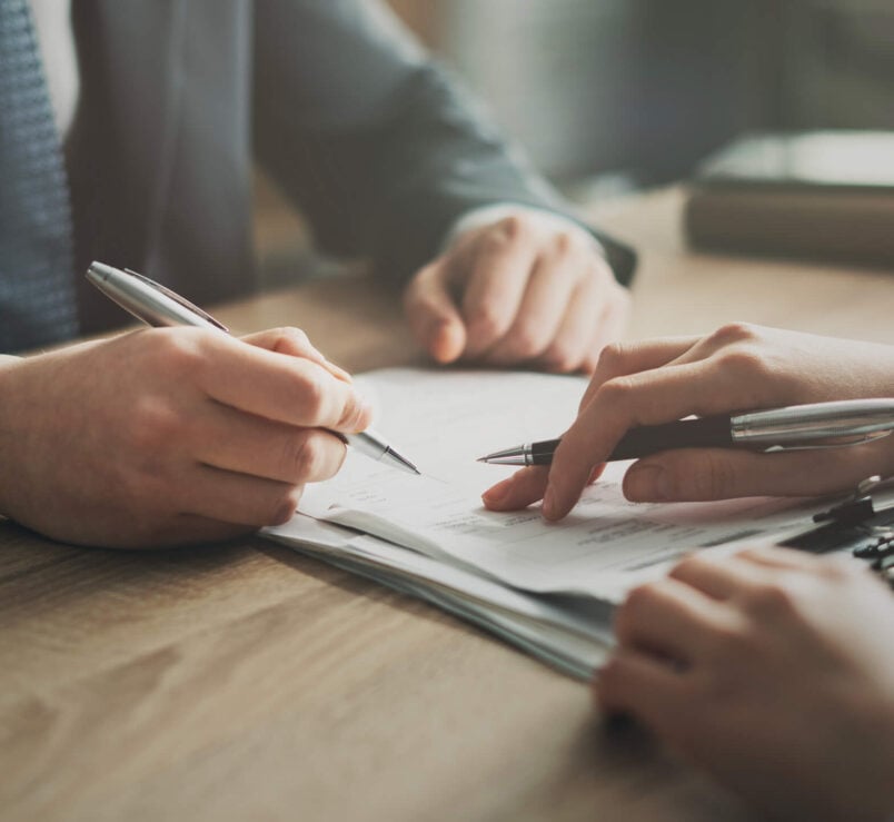 People signing documents