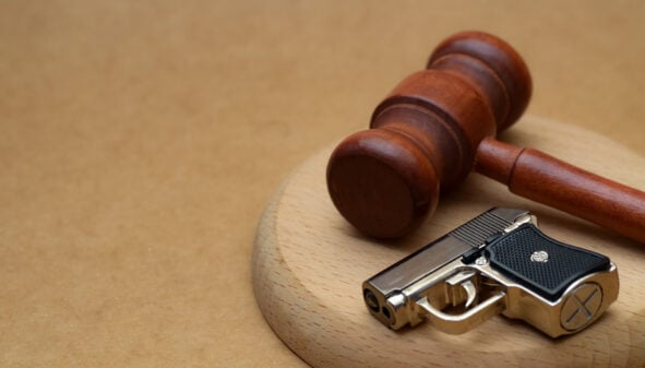 Judges gavel and small hand gun